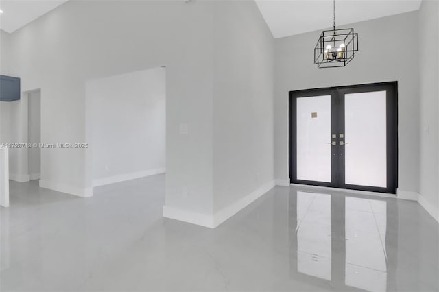 foyer entrance featuring french doors and an inviting chandelier