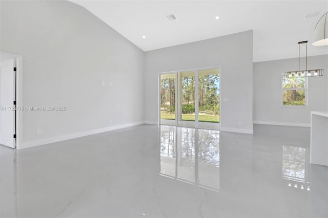 unfurnished room with a wealth of natural light and lofted ceiling