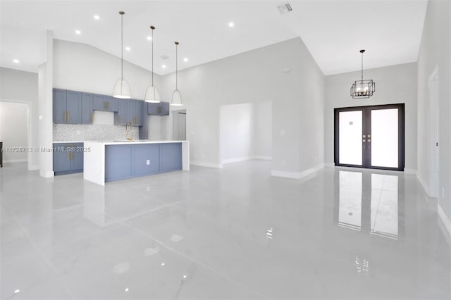 kitchen featuring tasteful backsplash, a large island, blue cabinetry, and pendant lighting