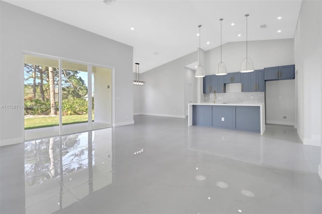 unfurnished living room with high vaulted ceiling and sink