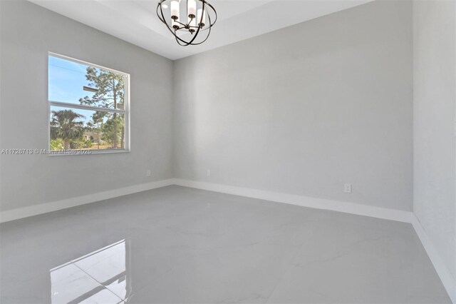 empty room featuring a notable chandelier