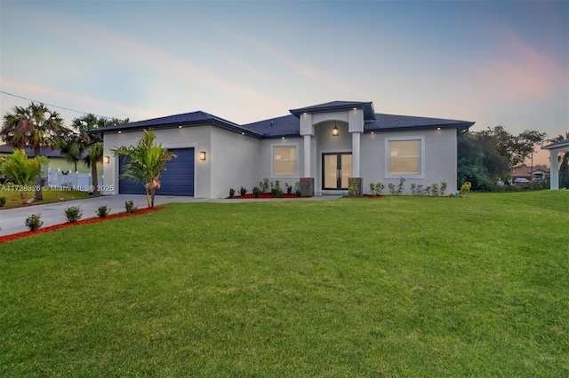 view of front of home featuring a garage and a lawn