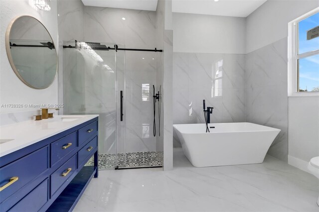 bathroom with shower with separate bathtub and vanity