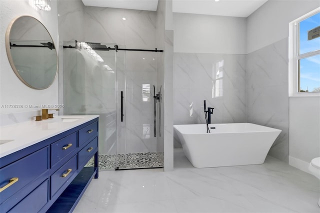 bathroom featuring vanity and shower with separate bathtub