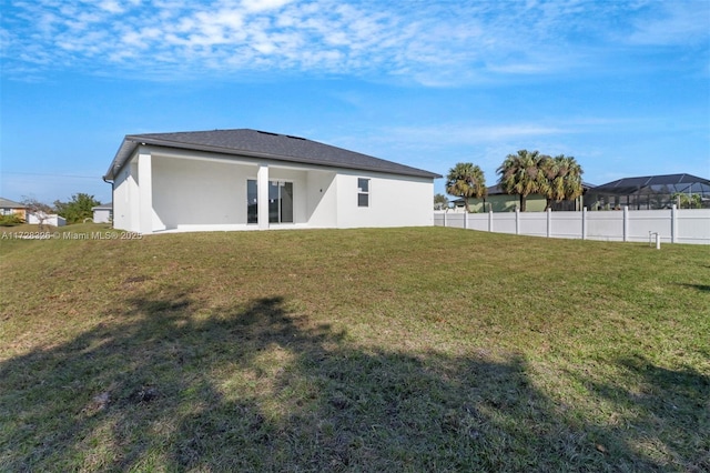 rear view of house with a yard