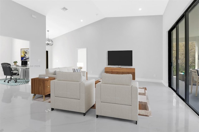 living room with high vaulted ceiling, a healthy amount of sunlight, and a notable chandelier