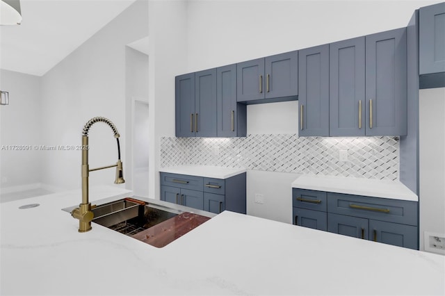 kitchen with lofted ceiling, sink, and decorative backsplash