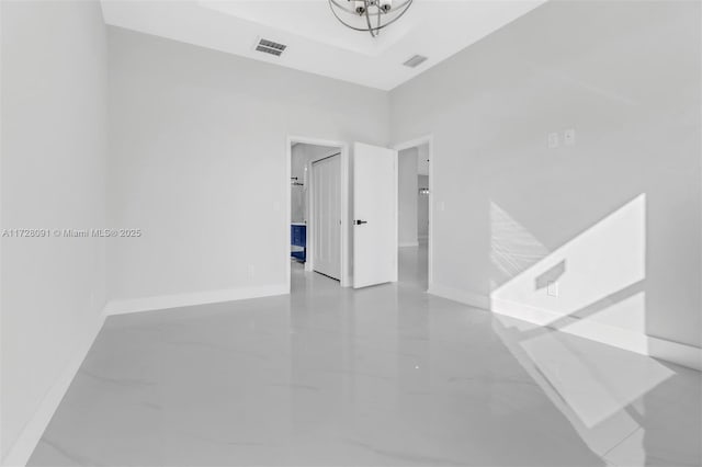 unfurnished room featuring a tray ceiling