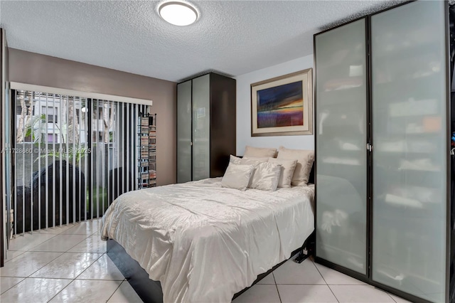 tiled bedroom featuring a textured ceiling