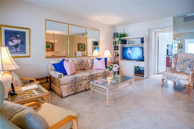 living room featuring light tile patterned flooring and an inviting chandelier