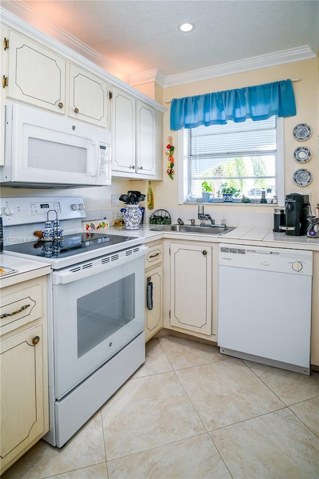 kitchen with crown molding, light tile patterned floors, sink, and white appliances