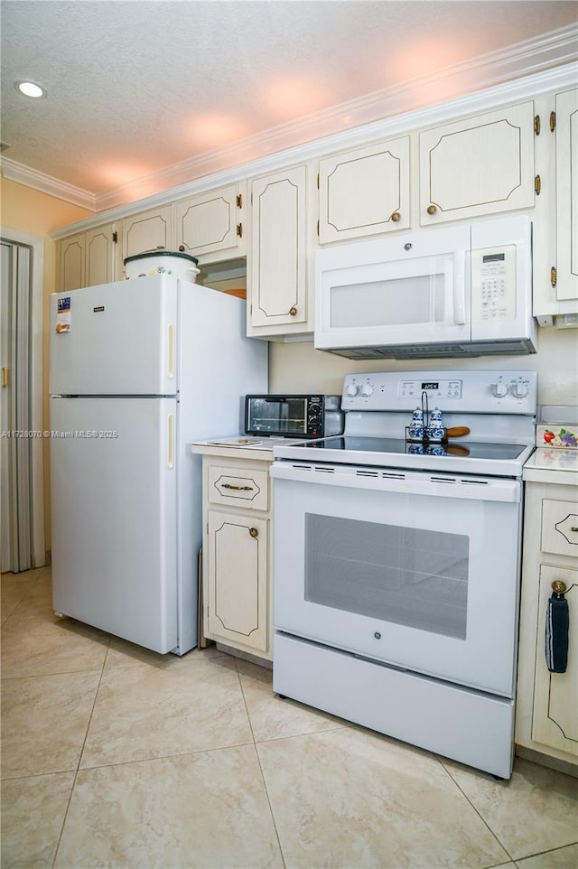 kitchen featuring a textured ceiling, light tile patterned floors, ornamental molding, and white appliances