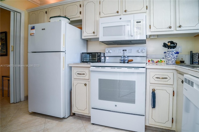 kitchen with white appliances and light tile patterned floors