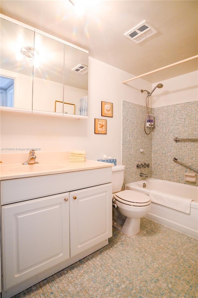 full bathroom with toilet, tiled shower / bath, and vanity