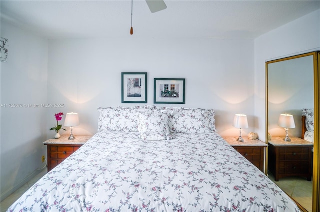 tiled bedroom with ceiling fan