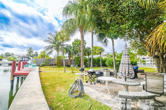 exterior space with a water view, a patio area, and a yard