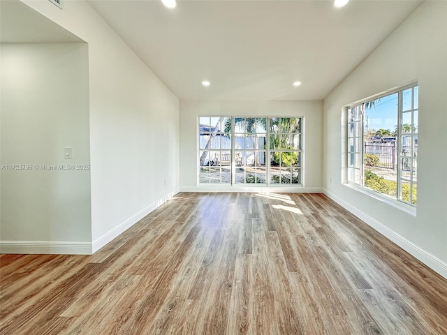 unfurnished living room with light hardwood / wood-style floors and lofted ceiling