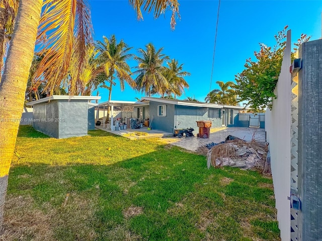 rear view of house featuring a patio and a yard