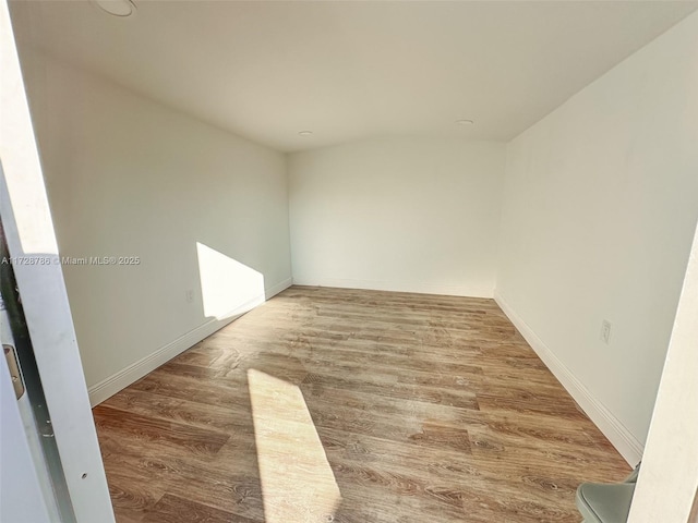 unfurnished room featuring hardwood / wood-style flooring