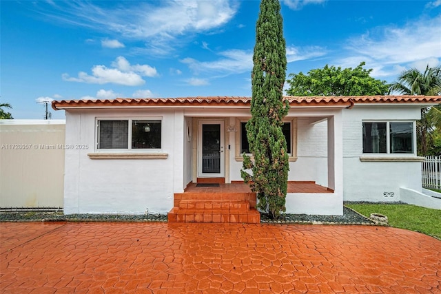 mediterranean / spanish-style house with a patio area