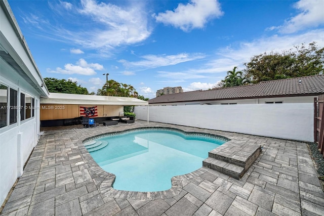 view of swimming pool with a patio area