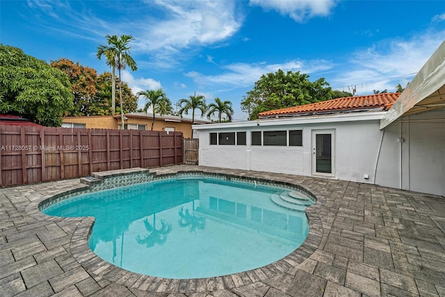 view of swimming pool featuring a patio area