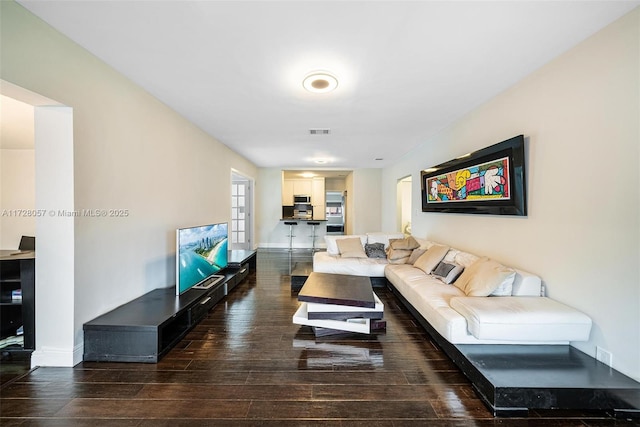 living room with dark hardwood / wood-style floors