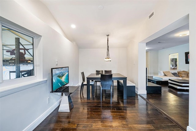 dining space with a wealth of natural light and dark hardwood / wood-style flooring