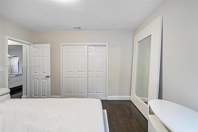 bedroom featuring a closet and dark hardwood / wood-style floors