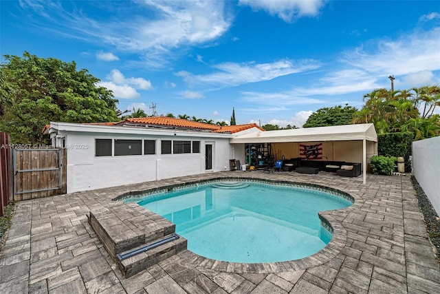 view of pool with outdoor lounge area and a patio