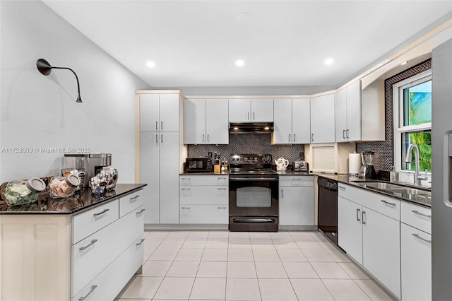 kitchen featuring white cabinets, sink, black appliances, and backsplash