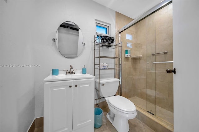 bathroom with tile patterned floors, toilet, vanity, and walk in shower