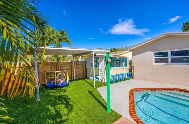 view of jungle gym featuring a patio area and a lawn