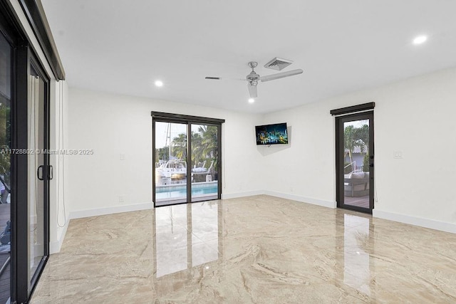 spare room with ceiling fan and a wealth of natural light