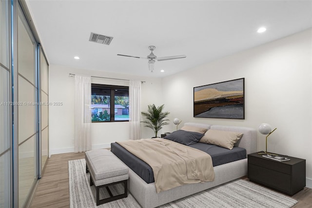 bedroom featuring ceiling fan and light hardwood / wood-style flooring