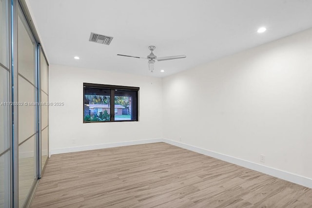 unfurnished room featuring light wood-type flooring and ceiling fan