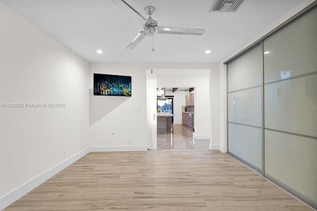 corridor with light wood-type flooring