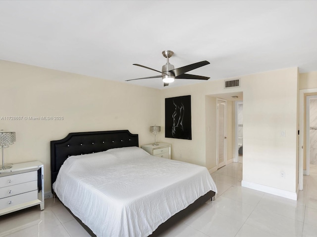 tiled bedroom featuring ceiling fan