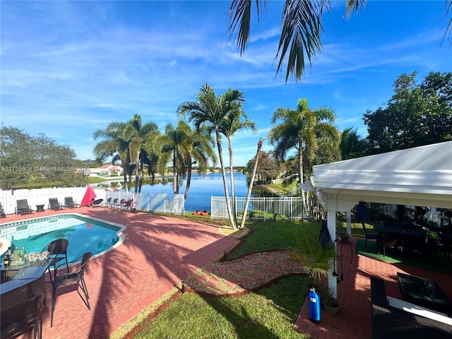 view of pool with a patio and a water view