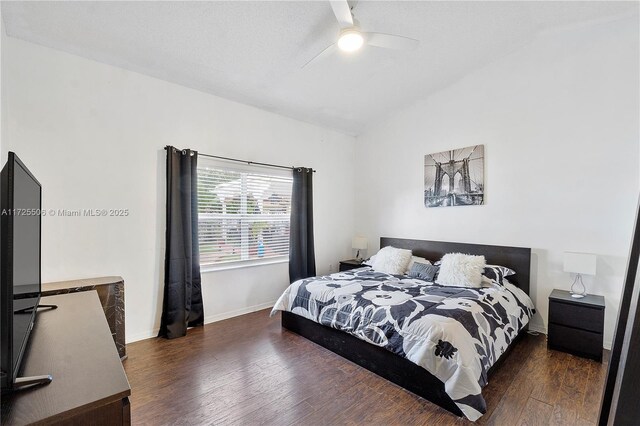 bedroom with lofted ceiling, dark hardwood / wood-style flooring, and ceiling fan