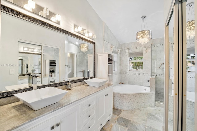 bathroom with separate shower and tub, vaulted ceiling, an inviting chandelier, and vanity