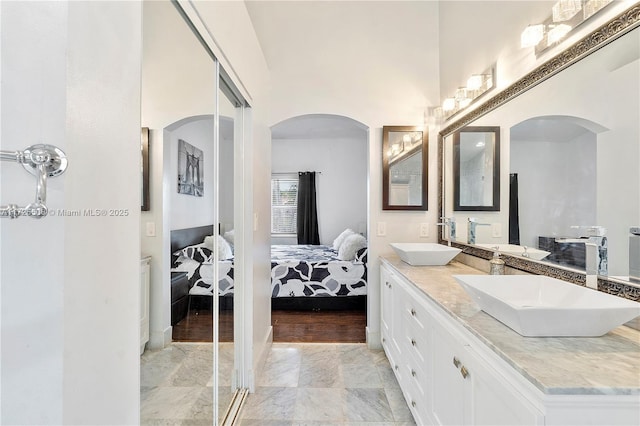 bathroom with vanity and a high ceiling