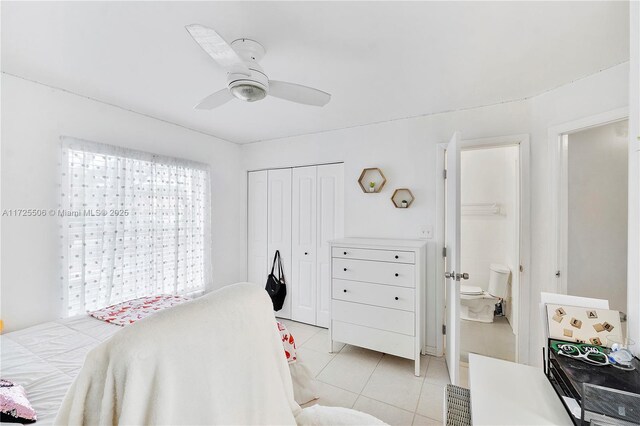 bedroom with ensuite bath, ceiling fan, and light tile patterned flooring