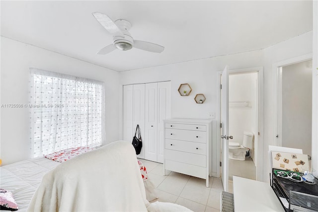 bedroom with ceiling fan, light tile patterned flooring, connected bathroom, and a closet