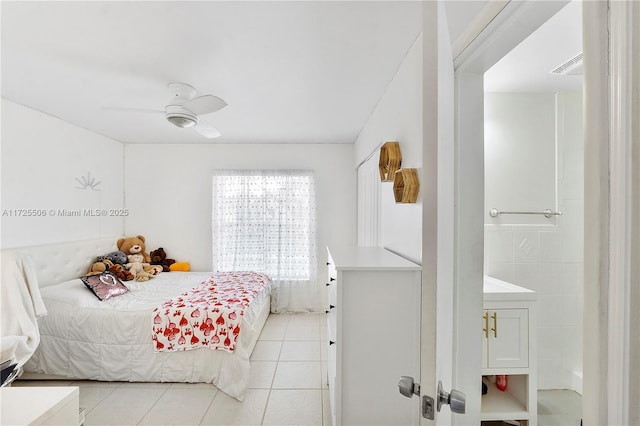 tiled bedroom featuring ceiling fan