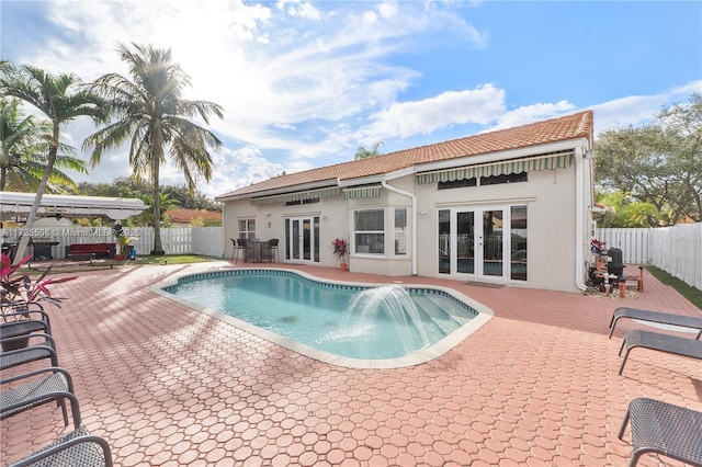 view of pool with a patio area and french doors