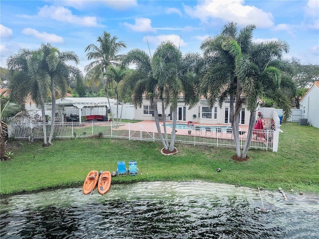 exterior space with a lawn, a water view, a swimming pool, and a patio