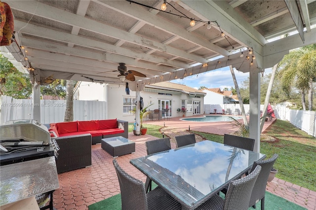 view of patio with an outdoor living space, a fenced in pool, and french doors