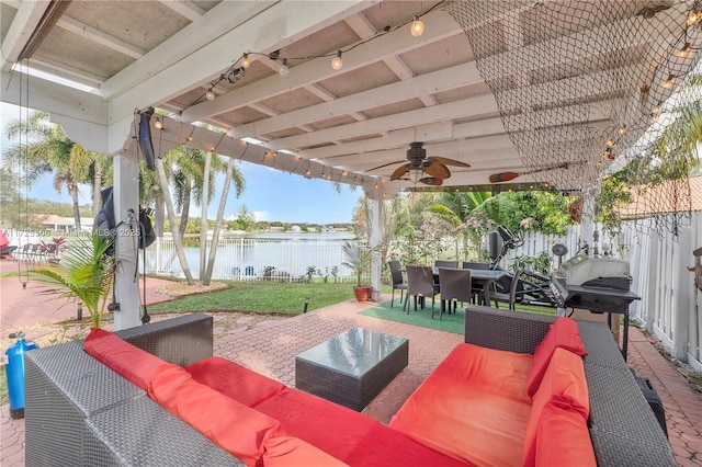 view of patio / terrace featuring outdoor lounge area, a water view, and ceiling fan