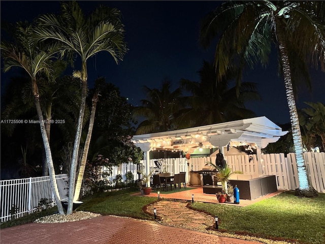 yard at twilight with a patio area and a pergola